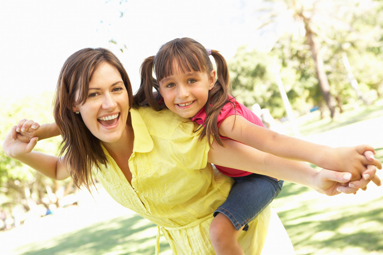 Mom-Daughter-Piggy-Back-Carrying-Girl-Outdoors-Smiling-Happy-106456876.jpg
